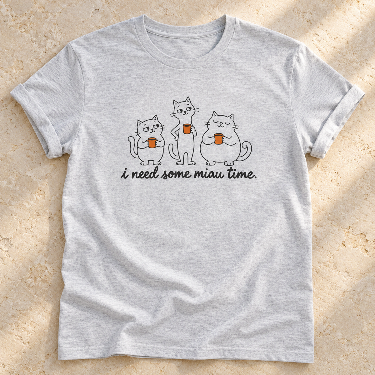 I Need Some Miau Time – Unisex Katzen-T-Shirt in Ash – natürliches Flatlay mit aufgekrempelten Ärmeln