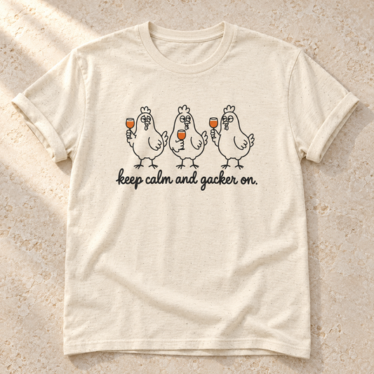 Keep Calm and Gacker On – Unisex Hühner-T-Shirt in Natural – natürliches Flatlay mit aufgekrempelten Ärmeln