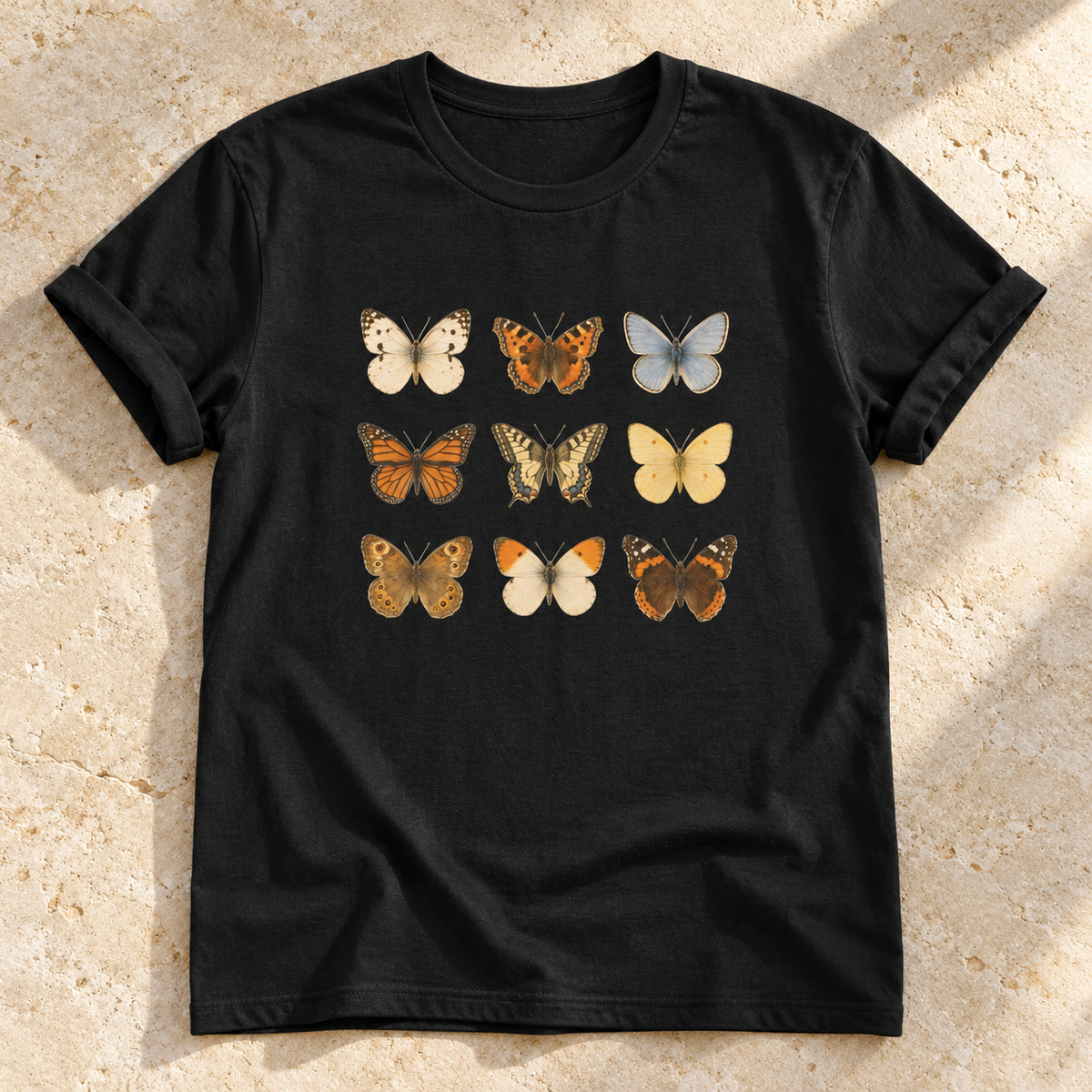 Schmetterlinge – Unisex Vintage-T-Shirt in Black – natürliches Flatlay mit aufgekrempelten Ärmeln